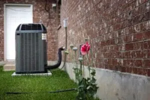 Air conditioning unit on the side of a brick house in Sandy, UT