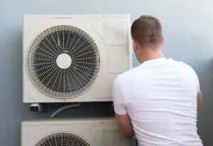 Male technician installing air-conditioning system in Sandy, UT