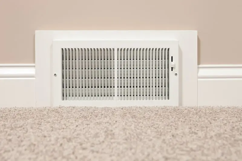 air vent at the base of a wall in a home