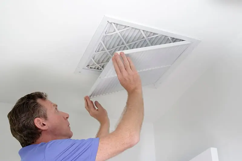 Blogs - Just Right man opening vent to replace air filter.