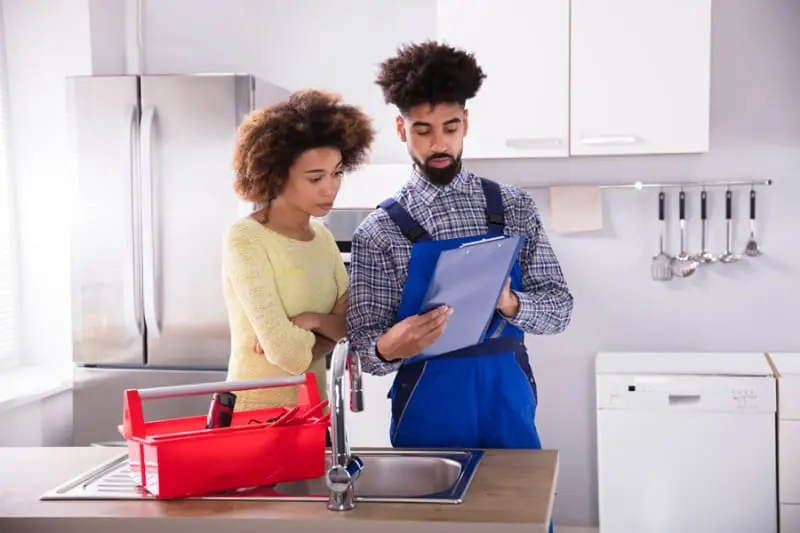 Blogs - Just Right Woman Signing Invoice For Air Conditioning installation Service In Kitchen.