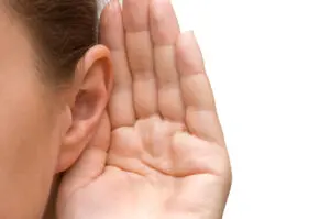 Girl listening with her hand on an ear for HVAC