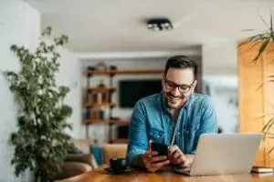 AC Maintenance Checklist. Man at desk with phone.