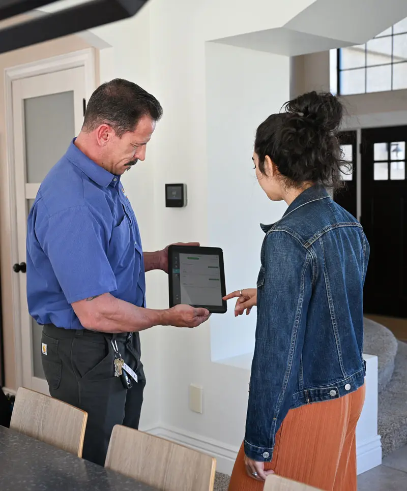just right team member showing customer maintenance reports on a tablet