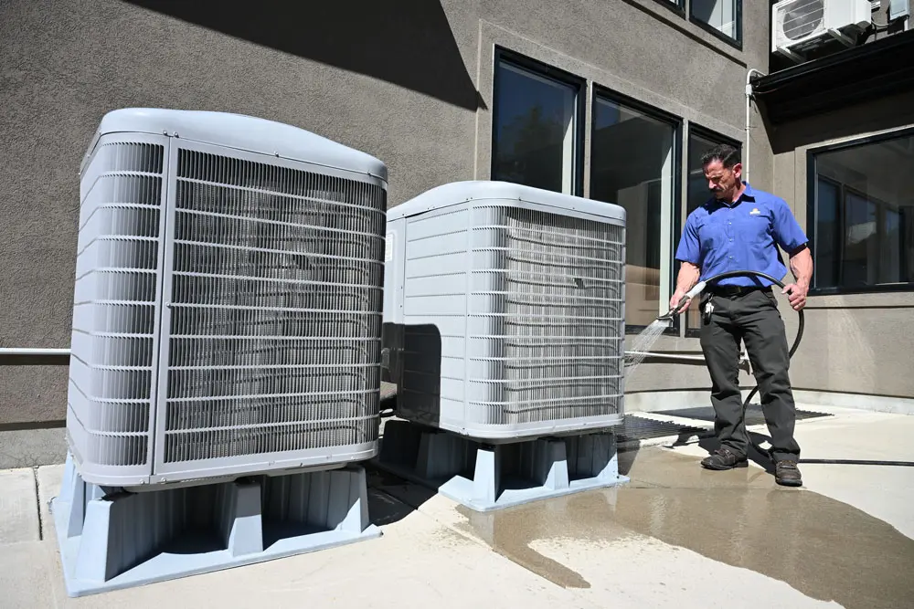 Blogs - Just Right Just Right employee looking at air conditioner