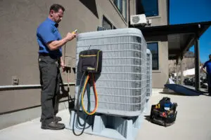 Just Right employee checking an ac unit