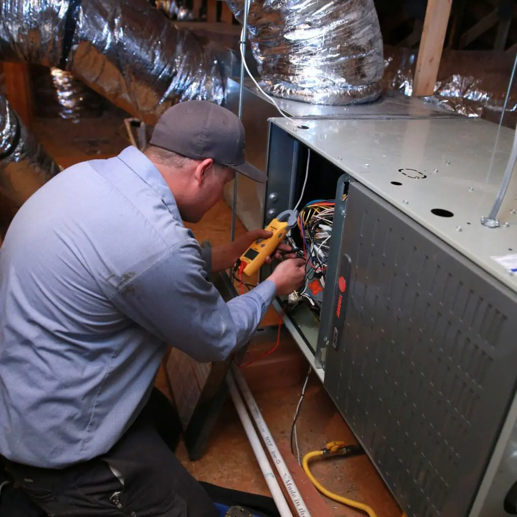 A professional fixing an HVAC system in Salt Lake City