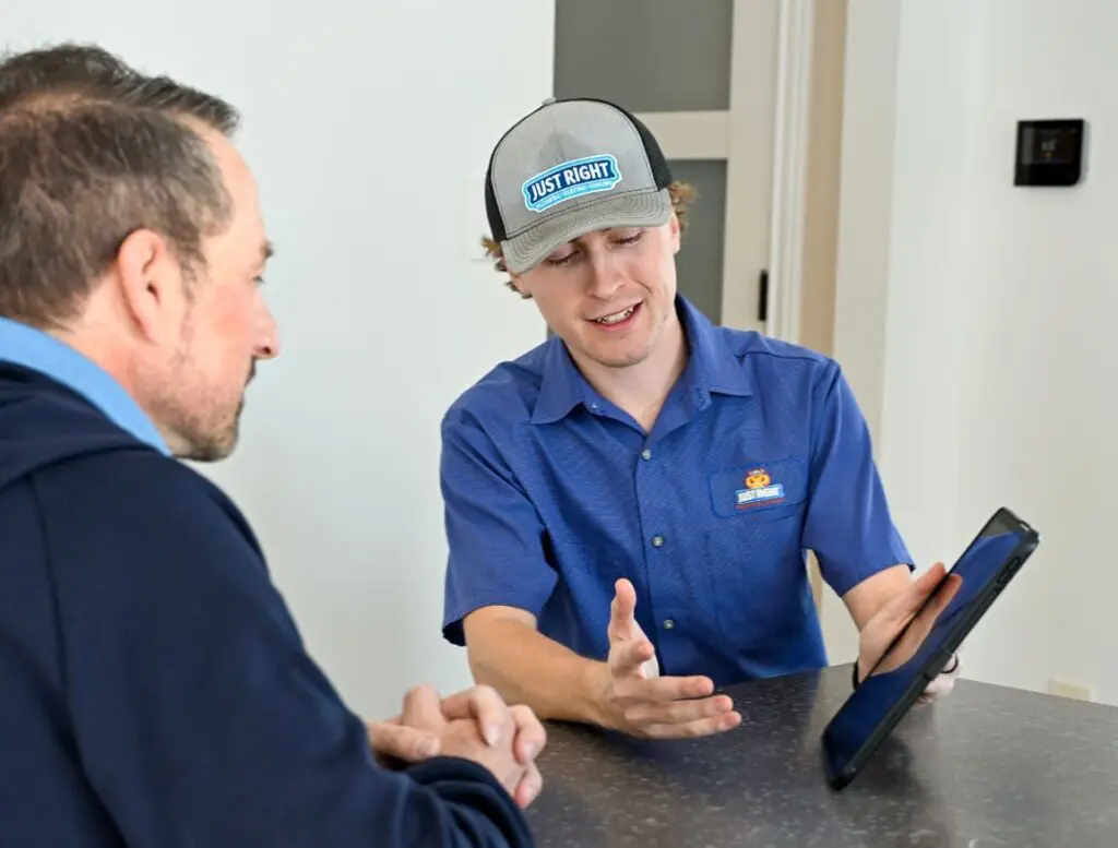 A Professional Talking With a Customer About Available HVAC Services in Salt Lake City
