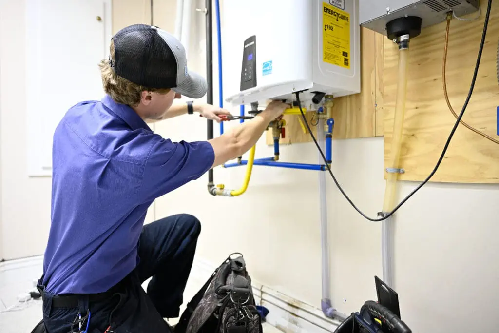 Emergency plumber near me in Layton, UT repairing burst water pipe