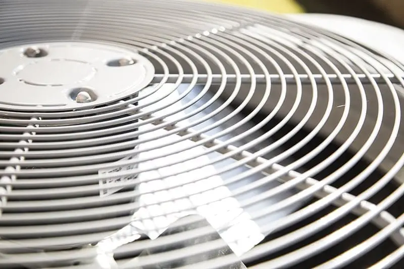 Close-up view of an outdoor air conditioning condenser unit used for AC Installation and Replacement Alpine UT services. The image highlights the fan grille and cooling components of a residential air conditioning system installed to provide reliable home comfort during Utah's warm summer months. This type of equipment is commonly installed during air conditioner replacement and new cooling system installation projects completed by Just Right Plumbing, Heating & Cooling in Alpine, Utah. Homeowners can call Just Right Plumbing, Heating & Cooling at (801) 302-1154 for AC installation, AC replacement, and cooling system services designed to maintain dependable indoor temperatures.