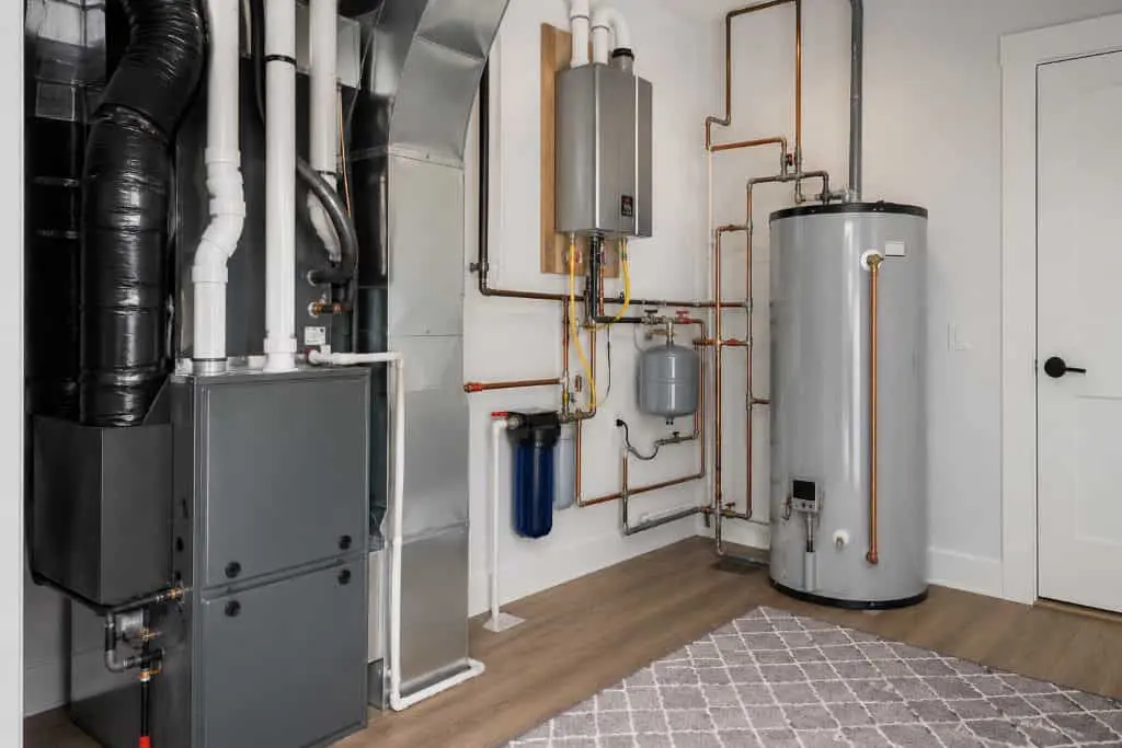 Home utility room with a furnace, tankless unit, and water heater from an HVAC & Plumbing Company in Alpine UT.