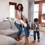 Why Air Duct Cleaning Is Important. A family dancing happily in their living room.