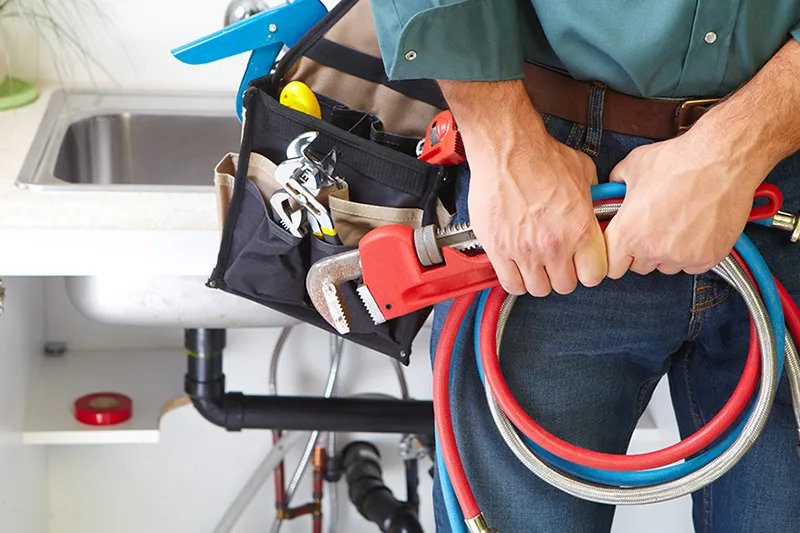 10 Signs You Need Professional Plumbing Services ASAP. Close up photo of a professional plumber's tool belt.