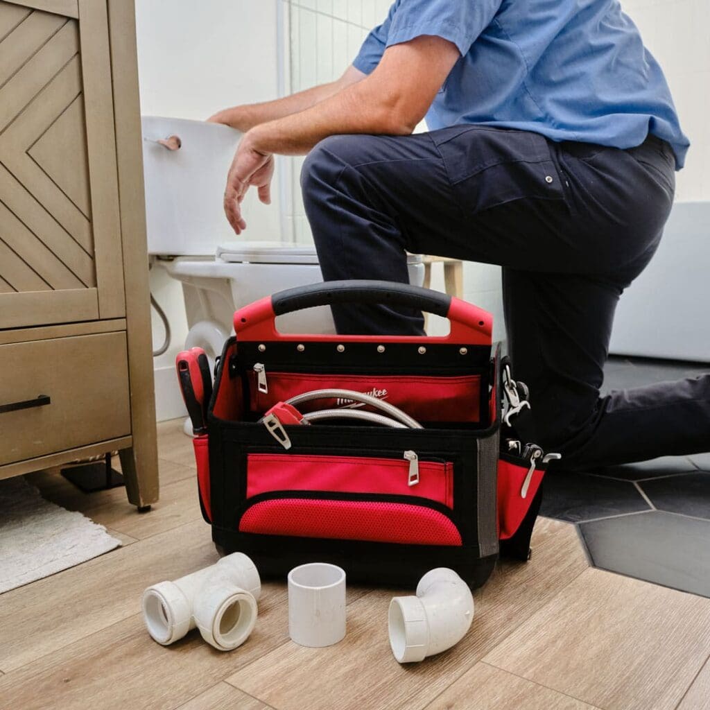A plumber fixing a toilet at a customer home in Salt Lake City