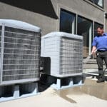 Just Right employee looking at air conditioner