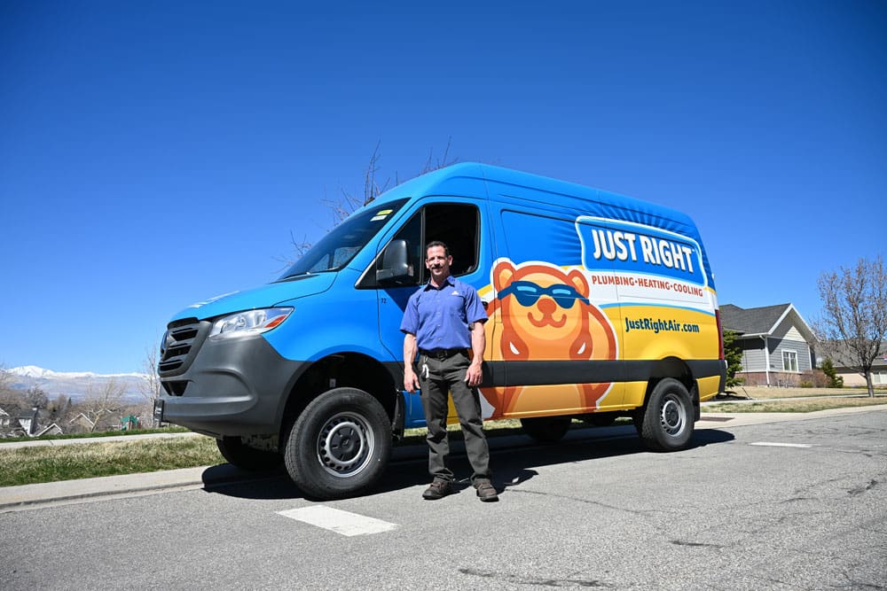 just right team member standing outside by his service van