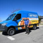 just right team member standing next to his service van