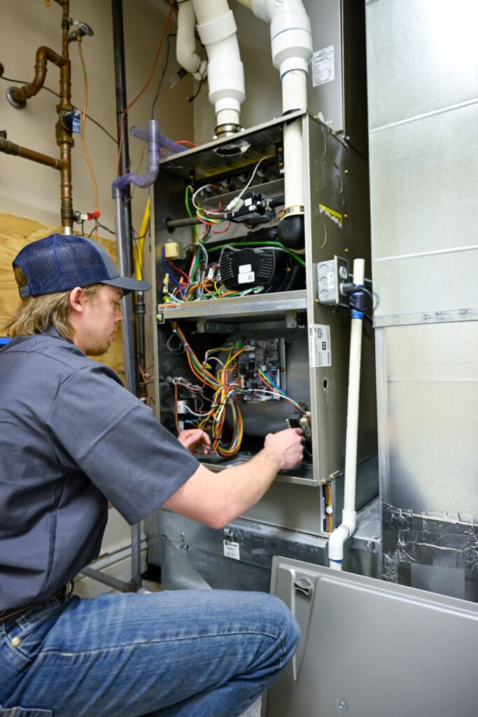 Salt Lake City Furnace Maintenance Services - Just Right just right team member repairing furnace