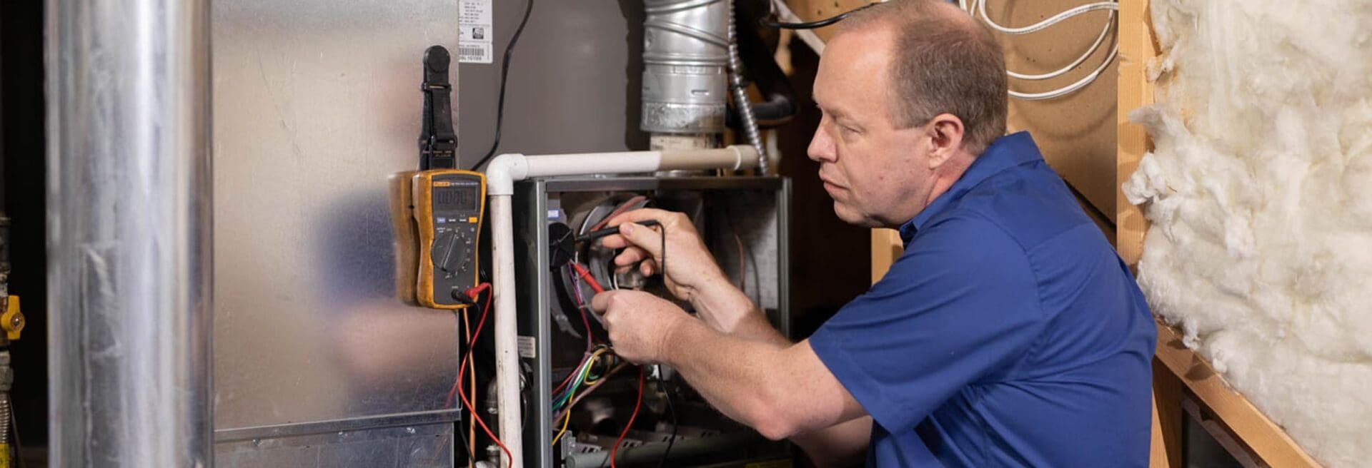 just team member repairing a furnace