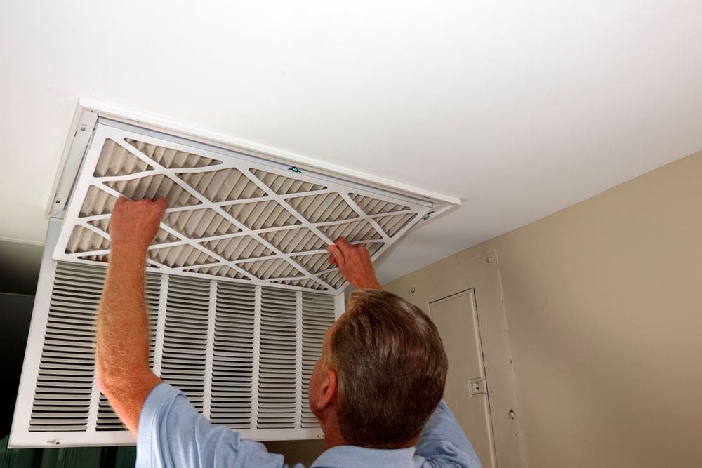Man maintaining indoor air conditioner