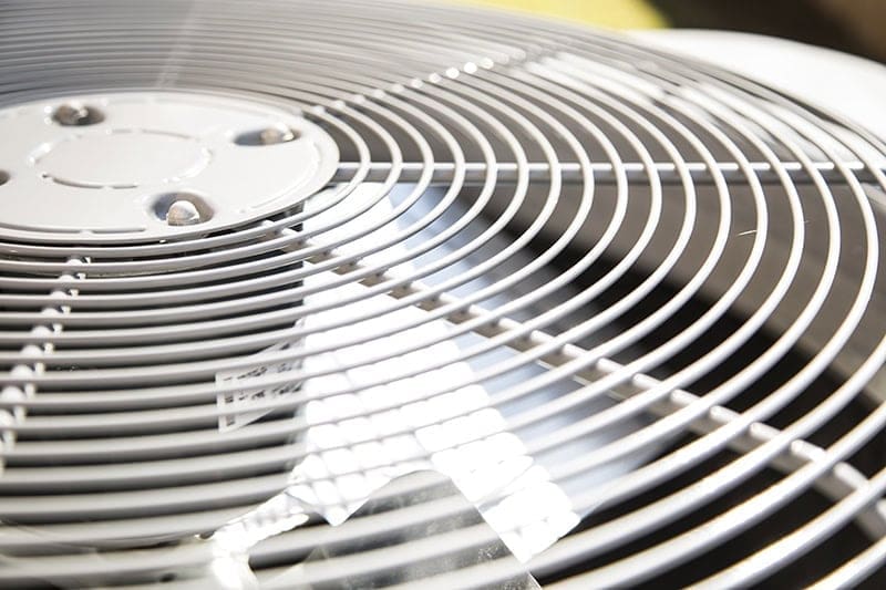 Close-up view of an outdoor air conditioning condenser unit used for AC Installation and Replacement Alpine UT services. The image highlights the fan grille and cooling components of a residential air conditioning system installed to provide reliable home comfort during Utah's warm summer months. This type of equipment is commonly installed during air conditioner replacement and new cooling system installation projects completed by Just Right Plumbing, Heating & Cooling in Alpine, Utah. Homeowners can call Just Right Plumbing, Heating & Cooling at (801) 302-1154 for AC installation, AC replacement, and cooling system services designed to maintain dependable indoor temperatures.