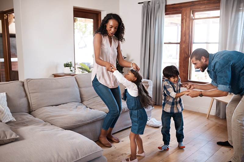 Why Air Duct Cleaning Is Important. A family dancing happily in their living room.