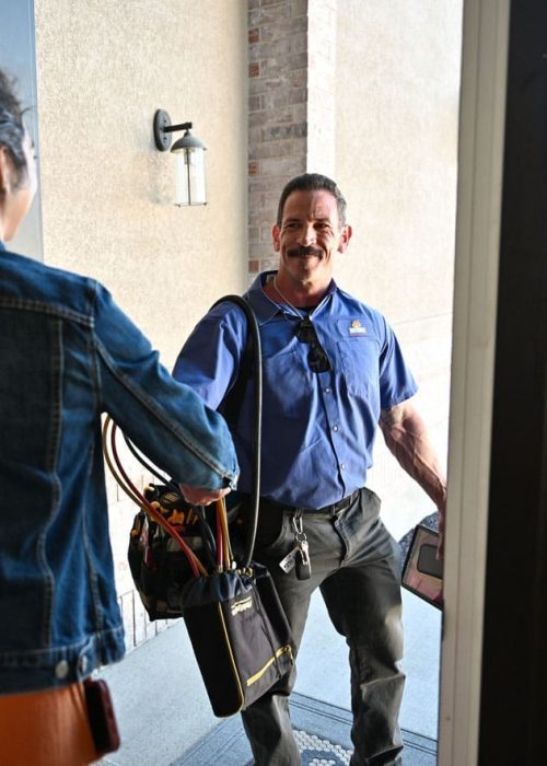 just right technician shaking the hand of a customer at the front door of their home