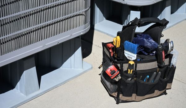maintenance toolkit sitting next to an air conditioner